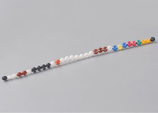 Side view of column of multicolored seed beads stitched together into a cohesive column